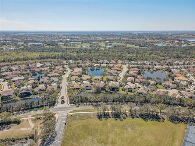 drone / aerial view featuring a residential view and a water view