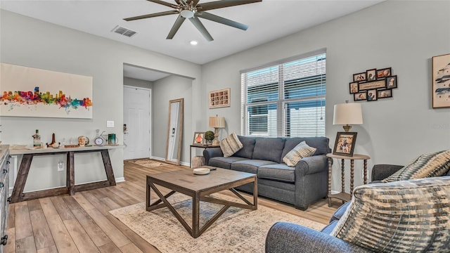 living area featuring visible vents, recessed lighting, light wood-style floors, baseboards, and ceiling fan