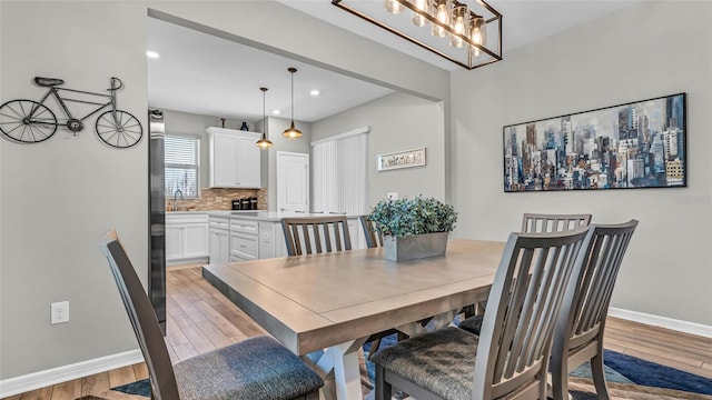 dining room featuring recessed lighting, baseboards, and light wood-style floors