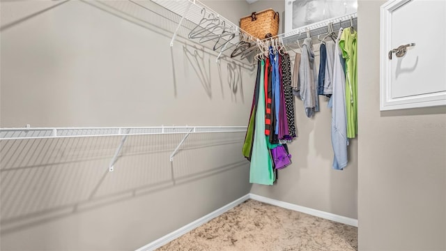 spacious closet with carpet flooring