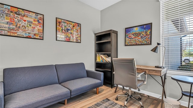 office area with baseboards and wood finished floors