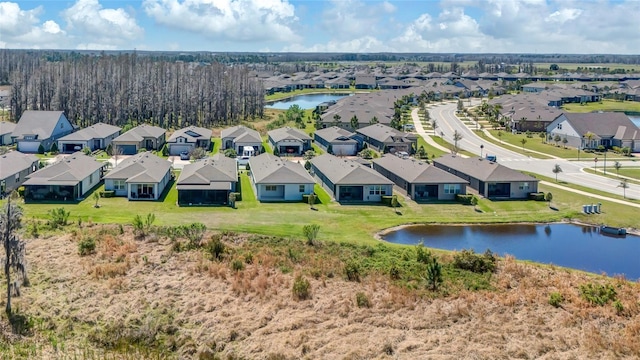 drone / aerial view with a residential view and a water view