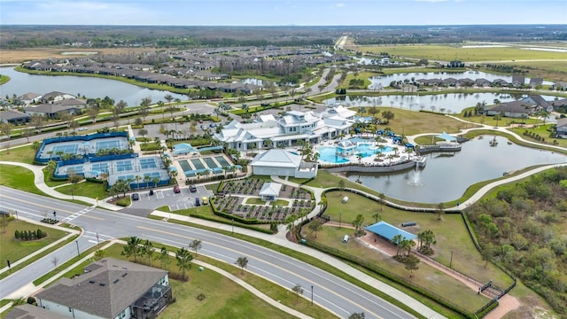 drone / aerial view featuring a water view and a residential view