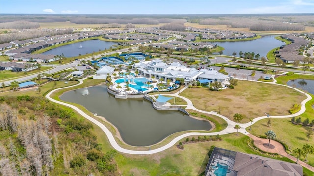 drone / aerial view featuring a residential view and a water view