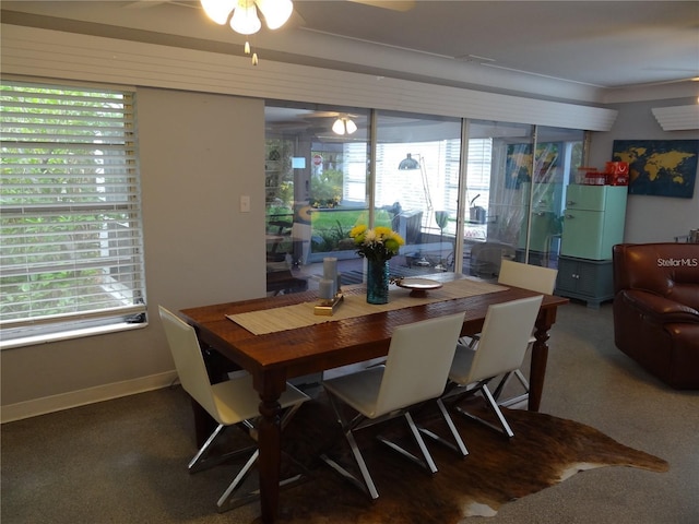 dining space with baseboards and ceiling fan