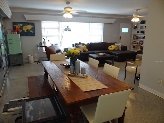 dining space with speckled floor, baseboards, and ceiling fan