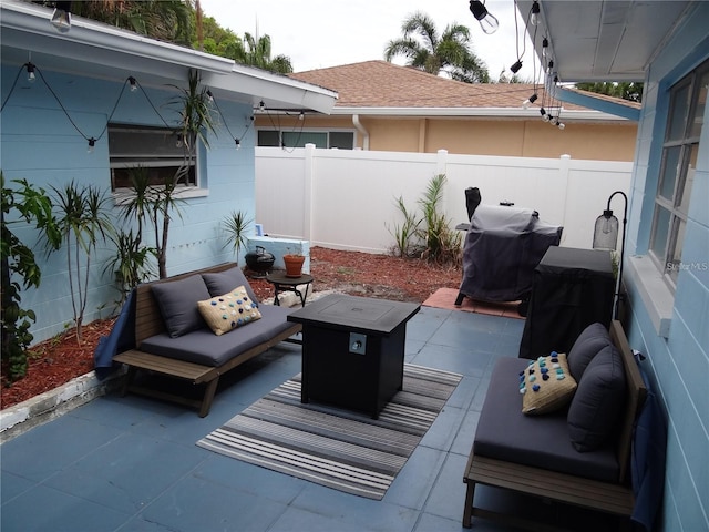 view of patio featuring grilling area, outdoor lounge area, and fence