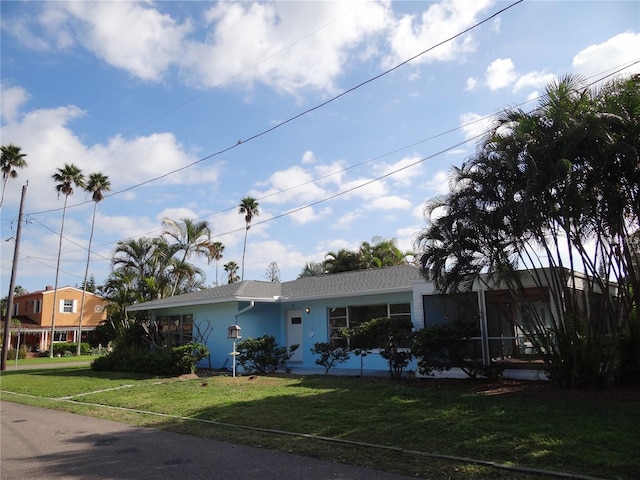 single story home with stucco siding and a front yard