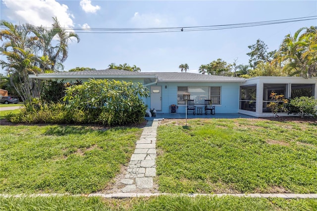 view of front facade featuring a front yard and a sunroom