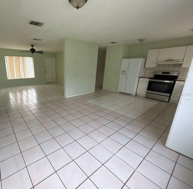 interior space with visible vents, light tile patterned flooring, and a ceiling fan