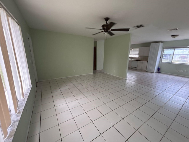 spare room featuring light tile patterned floors, a ceiling fan, and visible vents