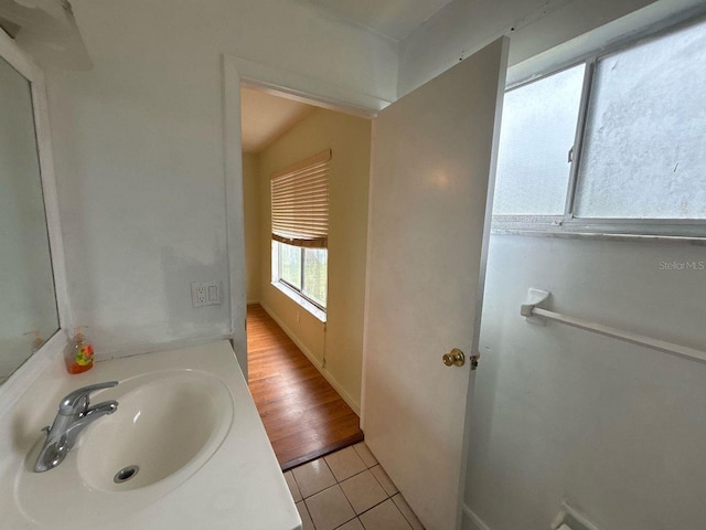 bathroom with a sink, baseboards, and tile patterned floors