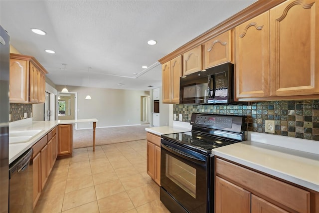 kitchen with light tile patterned floors, black appliances, and light countertops