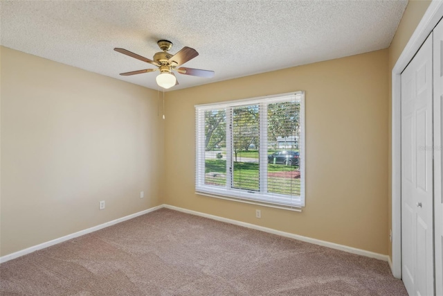 unfurnished bedroom with a closet, a textured ceiling, baseboards, and carpet floors