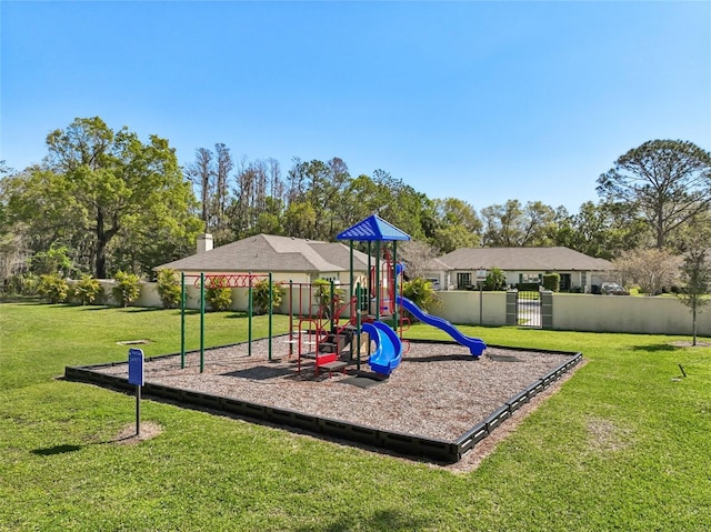 community playground featuring a lawn and fence