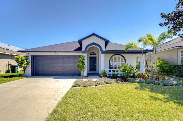 ranch-style house with stucco siding, driveway, roof with shingles, a front yard, and a garage