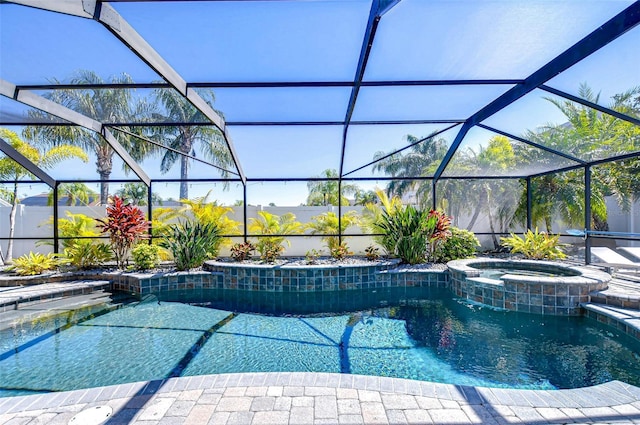 view of pool with a lanai and a pool with connected hot tub