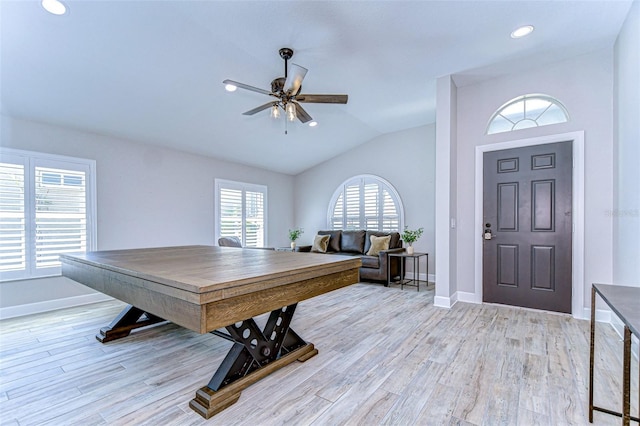 foyer with light wood-type flooring, lofted ceiling, baseboards, and a ceiling fan