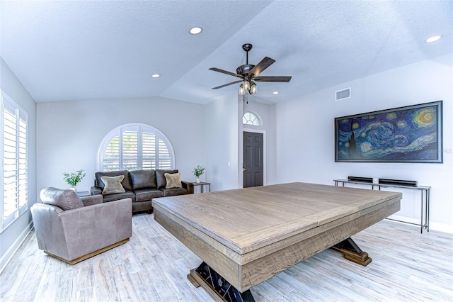 recreation room with a ceiling fan, visible vents, light wood finished floors, recessed lighting, and vaulted ceiling