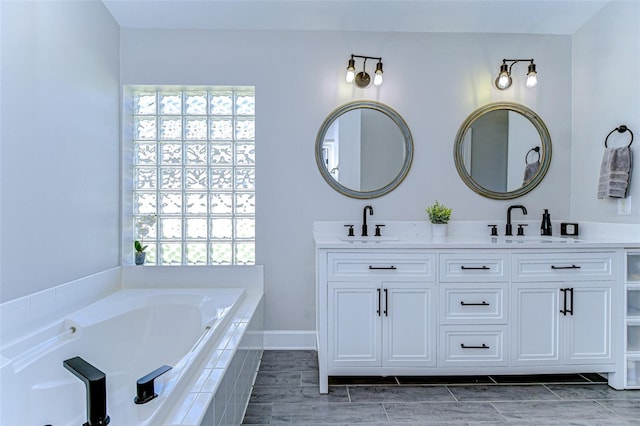 full bathroom with a sink, wood finish floors, and double vanity