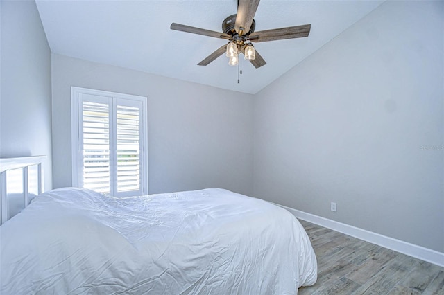 bedroom with baseboards, light wood-type flooring, and ceiling fan