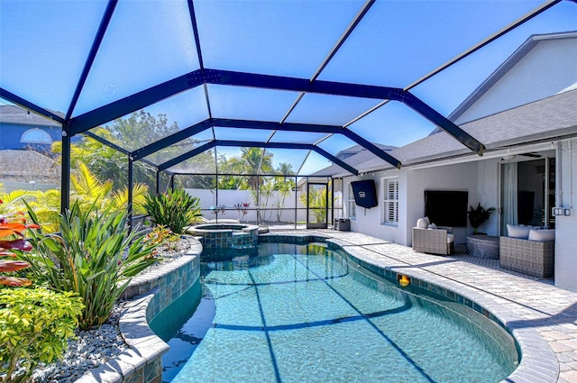 view of swimming pool with a pool with connected hot tub, a lanai, and a patio area