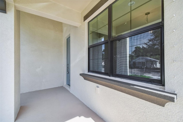 entrance to property with stucco siding