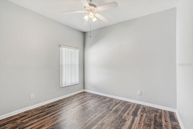 spare room with dark wood-type flooring, baseboards, and ceiling fan