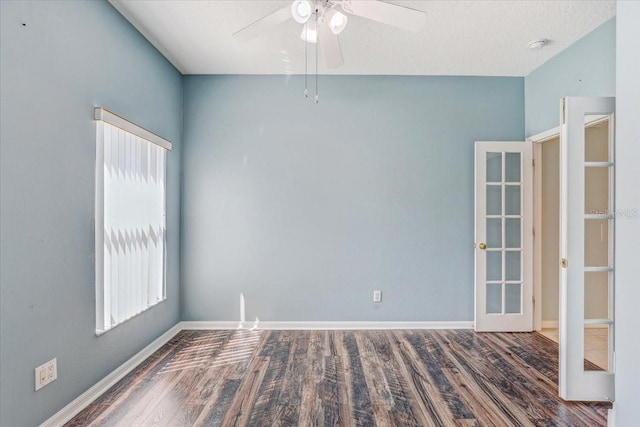 unfurnished room with wood finished floors, french doors, baseboards, and ceiling fan