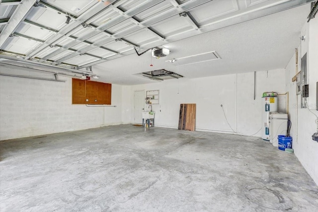 garage with electric water heater, a garage door opener, and a sink