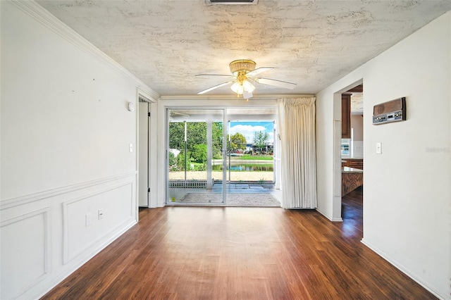 spare room featuring a ceiling fan, wood finished floors, and visible vents