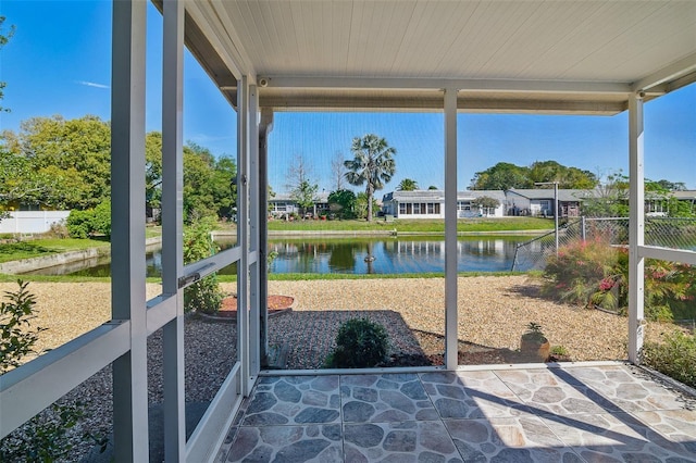 sunroom / solarium featuring a water view