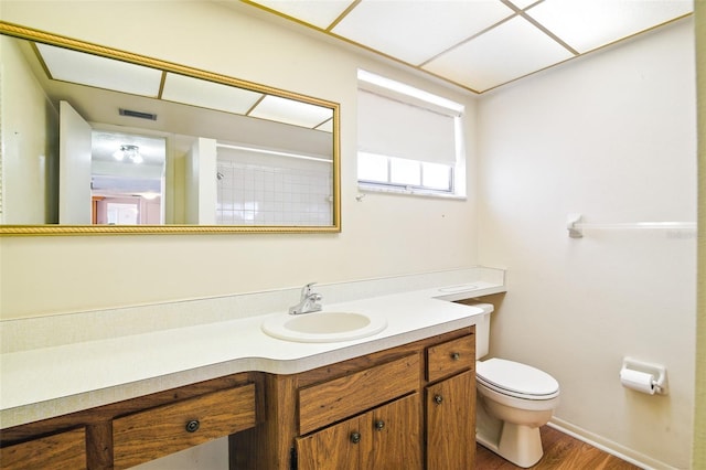 bathroom with visible vents, toilet, wood finished floors, and vanity