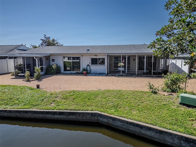 rear view of property with a yard, fence, and a sunroom