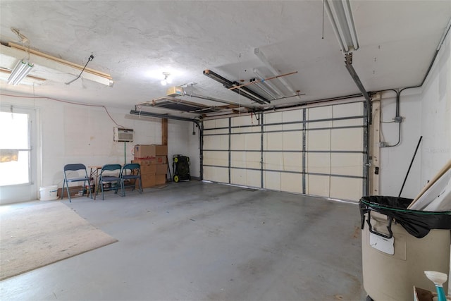 garage featuring a garage door opener and a wall mounted AC