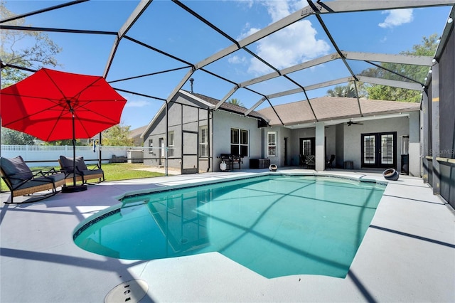 view of swimming pool with a ceiling fan, a patio, french doors, and fence