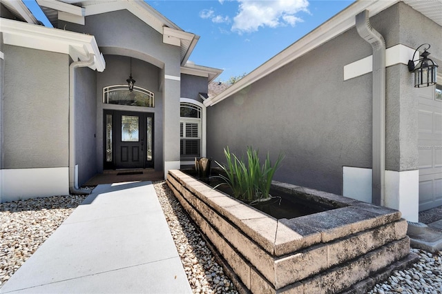 property entrance featuring stucco siding