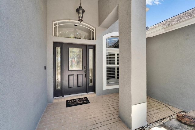 property entrance with stucco siding