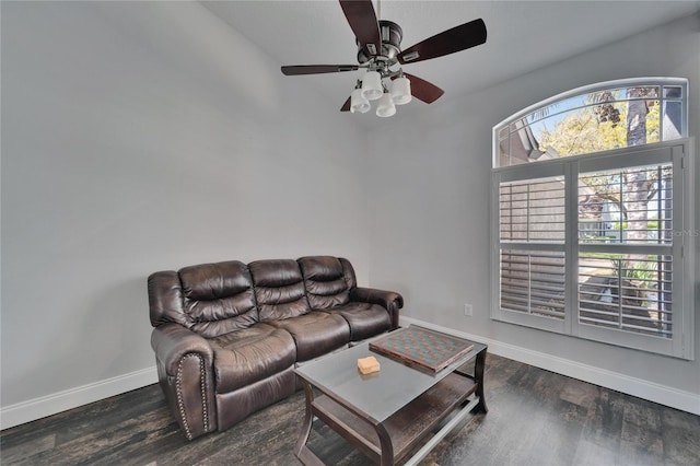 living area with baseboards and wood finished floors