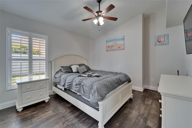 bedroom featuring baseboards, dark wood-type flooring, lofted ceiling, and a ceiling fan