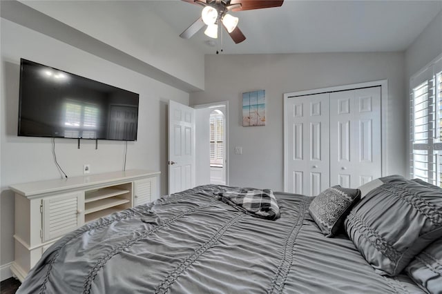 bedroom with a closet, ceiling fan, and vaulted ceiling