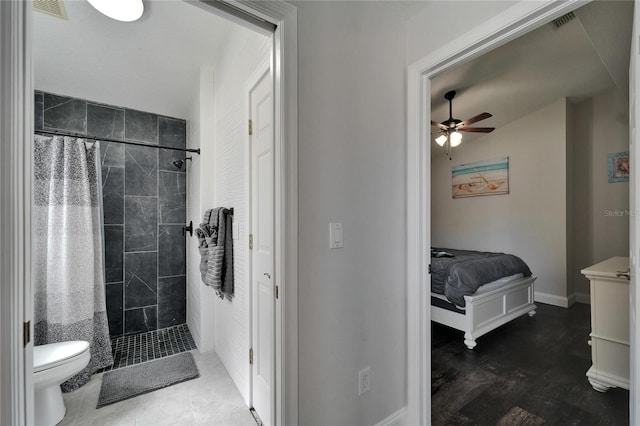 ensuite bathroom with a ceiling fan, visible vents, a tile shower, toilet, and connected bathroom