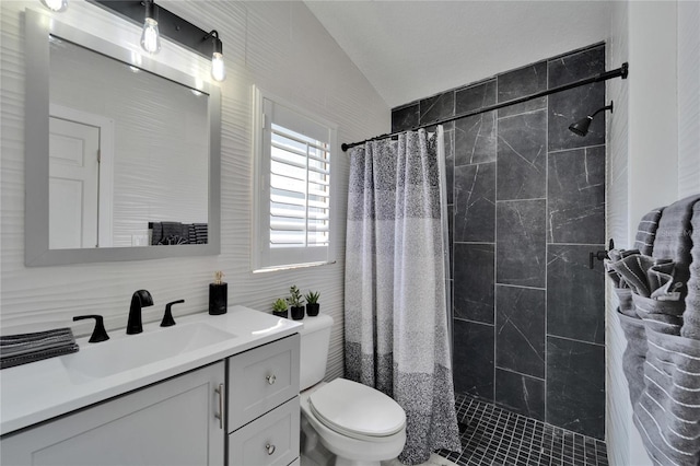 bathroom with vanity, tiled shower, lofted ceiling, tile walls, and toilet