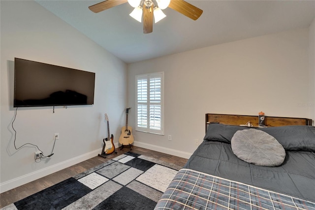 bedroom featuring baseboards, wood finished floors, a ceiling fan, and vaulted ceiling