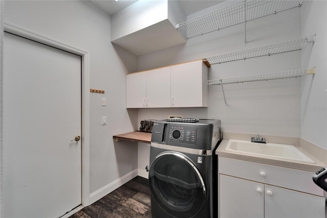 laundry room with dark wood-style floors, baseboards, washer / clothes dryer, cabinet space, and a sink