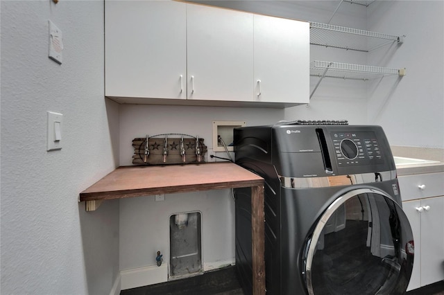 washroom with washer / dryer and cabinet space