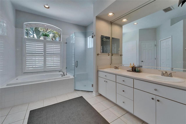 full bathroom with visible vents, a garden tub, a sink, a shower stall, and tile patterned flooring