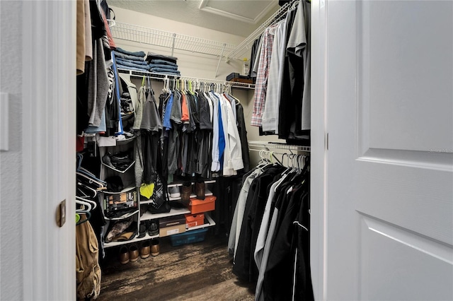 spacious closet featuring attic access and wood finished floors