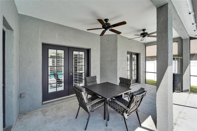 view of patio / terrace with outdoor dining area, french doors, fence, and ceiling fan