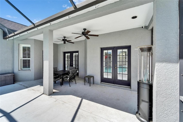 view of patio with french doors, glass enclosure, and a ceiling fan